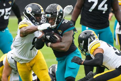 Jaguars running back James Robinson (30) is hit by Pittsburgh Steelers inside linebacker Vince Williams (98) and free safety Minkah Fitzpatrick (39) during a Nov. 22 game. (WILL DICKEY/TNS)