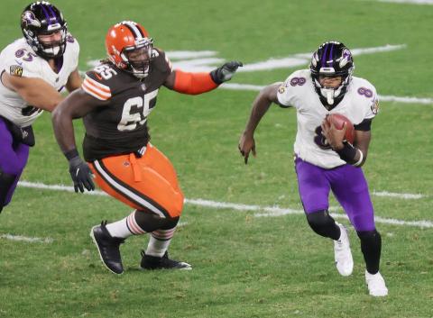 Baltimore quarterback Lamar Jackson scrambles away from pressure Monday night against Cleveland. (JOHN KUNTZ/cleveland.com/TNS)