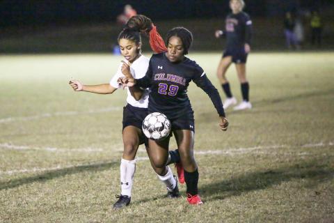 Columbia’s Olivia Kelly fights for possession of the ball with Fort White’s Alyssa Hopkins during Wednesday night’s match. (BRENT KUYKENDALL/Lake City Reporter)