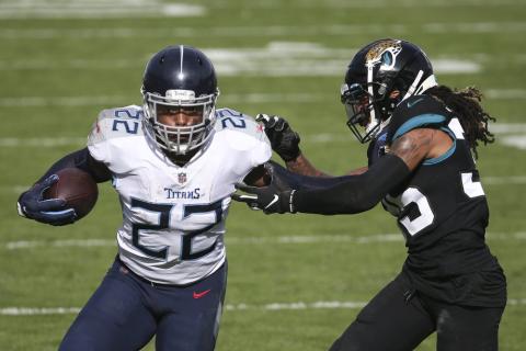 Tennessee Titans running back Derrick Henry (22) gains yardage as he tries to get around Jacksonville Jaguars cornerback Sidney Jones on Sunday in Jacksonville. (STEPHEN B. MORTON/Associated Press)