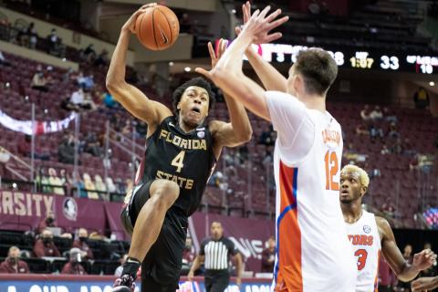 Florida State's Scottie Barnes drives on Florida's Colin Castleton during Saturday's game in Tallahassee. (MIGUEL OLIVELLA/Courtesy of ACC)