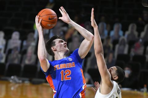 Florida forward Colin Castleton (12) shoots as Vanderbilt forward Dylan Disu defends on Wednesday in Nashville, Tenn. Florida won 91-72. (JOHN AMIS/Associated Press)