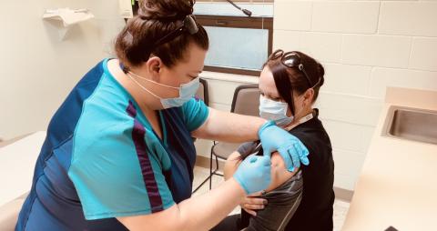 Front line staff member Sara Driggers (left) administers the first Moderna covid-19 vaccine allocated to the Columbia County Health Department to Sarah White. The health department will begin administering vaccinations to residents, 65 and older, on Monday. (COURTESY)