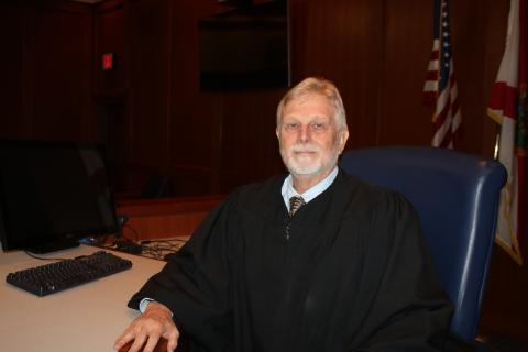 Tom Coleman, who has served as the Columbia County Judge for 18 years, sits at the bench in a Columbia County courtroom. Coleman, who has worked in the local courts system for more than four decades, retired Thursday. (TONY BRITT/Lake City Reporter)