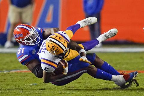 Florida linebacker Ventrell Miller (51) tackles LSU wide receiver Koy Moore after a reception on Saturday in Gainesville. (JOHN RAOUX/Associated Pressx)