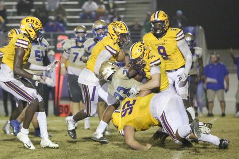 Columbia linebacker Jaden Dunn (15), defensive end A’Deon Farmer (7) and defensive lineman Nate Walmsley (92) tackle Daytona Beach Mainland running back Gregory Mango during last Friday’s Region 1-6A semifinal. (BRENT KUYKENDALL/Lake City Reporter)