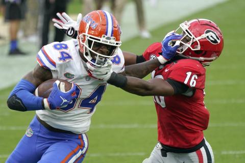 Florida tight end Kyle Pitts (84) tries to get past Georgia defensive back Lewis Cine (16) after a reception on Nov. 7 in Jacksonville. The Southeastern Conference championship game features two of the nation’s top playmakers, and neither is a quarterback. Alabama receiver DeVonta Smith and Florida tight end Kyle Pitts are the real stars of the league’s most potent offenses. (AP FILE PHOTO)