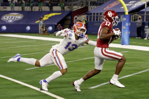 Florida defensive back Donovan Stiner (13) is unable to stop Oklahoma wide receiver Marvin Mims (17) from reaching the end zone on a touchdown reception during the first half of the Cotton Bowl on Wednesday in Arlington, Texas. (MICHAEL AINSWORTH/Associated Press)