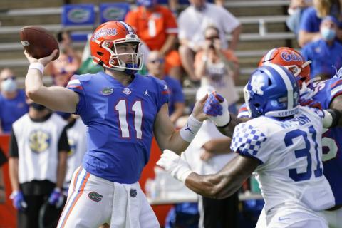 Florida quarterback Kyle Trask (11) throws a pass as Kentucky linebacker Jamar Watson (31) rushes on Saturday in Gainesville. (JOHN RAOUX/Associated Press)