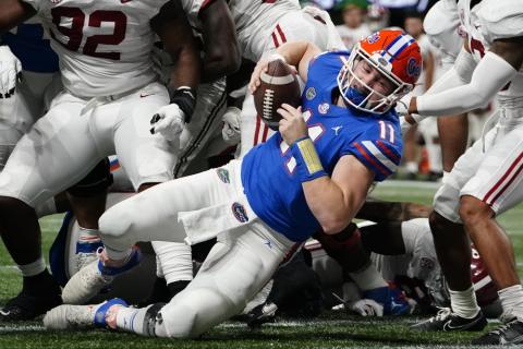 Florida quarterback Kyle Trask (11) leaps into the end zone for a touchdown against Alabama during the first half of the Southeastern Conference championship on Saturday in Atlanta. (BRYNN ANDERSON/Associated Press)