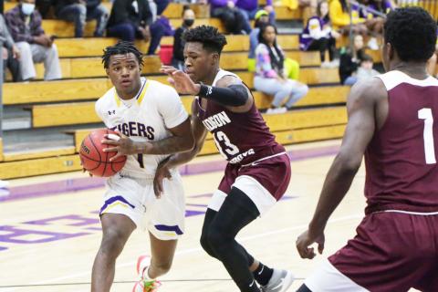 Columbia guard Tray Tolliver looks to pass as Madison County guard Jamie Hampton defends on Thursday. (BRENT KUYKENDALL/Lake City Reporter)