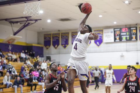 Columbia forward Marcus Peterson flies toward the basket for a slam dunk against Baker County on Friday night. Peterson finished with a game-high 16 points for the Tigers. (BRENT KUYKENDALL/Lake City Reporter)