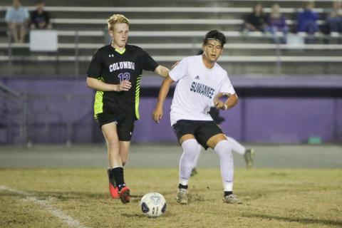 Columbia’s Zack Strickland chases down possession during Tuesday’s match against Suwannee. (BRENT KUYKENDALL/Lake City Reporter)