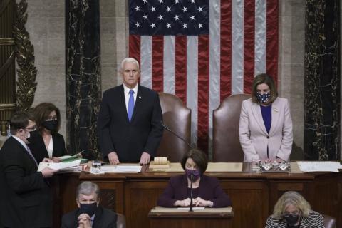 Vice President Mike Pence and Speaker of the House Nancy Pelosi, D-Calif., read the final certification of Electoral College votes cast in November's presidential election during a joint session of Congress after working through the night and into Thursday at the Capitol in Washington. Violent protesters loyal to President Donald Trump stormed the Capitol Wednesday, disrupting the process. (J. SCOTT APPLEWHITE/AP Pool Photo)