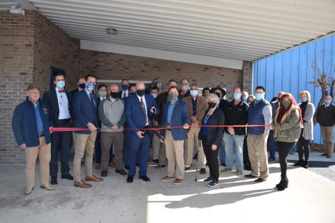 Lawrence Barrett, Florida Gateway College president, prepares to cut the ribbon Thursday afternoon at the grand opening of the college’s new multipurpose building in the former Boys Club of Columbia County facility. Joining Barrett were FGC officials, Florida Chancellor of Career Technical Programs Henry Mack and local dignitaries and residents. (COURTESY FLORIDA GATEWAY COLLEGE)
