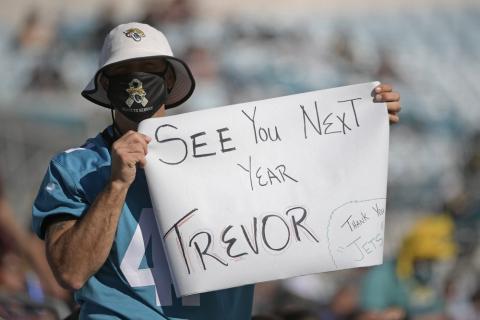 A Jacksonville Jaguars fan hold up a sign hoping that Clemson quarterback Trevor Lawerence will be the first pick for the Jacksonville Jaguars during a game against the Chicago Bears on Dec. 27, 2020, in Jacksonville. (PHELAN M. EBENHACK/Associated Press)
