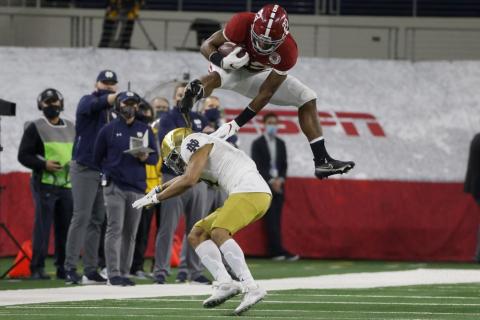 Alabama running back Najee Harris (22) fights off a tackle attempt by Notre Dame linebacker Marist Liufau (35) in the first half of the Rose Bowl on Jan. 1 in Arlington, Texas. (MICHAEL AINSWORTH/Associated Press)