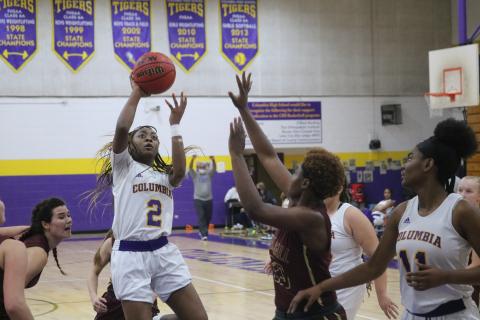 Columbia guard Na’Haviya Paxton puts up a shot over Oak Hall guard Tyla Young during Friday night’s game. Paxton had a triple-double with 20 points, 10 rebounds and 10 assists. (JORDAN KROEGER/Lake City Reporter)