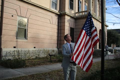 Jay Swisher, Columbia County Clerk of Court, hoists a flag over the Columbia County Courthouse Wednesday that was flown over the U.S. Capitol. (TONY BRITT/Lake City Reporter)