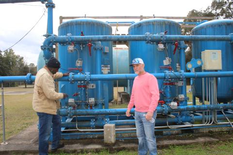 Vernon Zinnerman (from left), Fort White public works director shows Ronnie Frazier, Fort White mayor, the town’s water plant’s charcoal filter system, as they visually inspect the plant Friday afternoon. (TONY BRITT/Lake City Reporter)