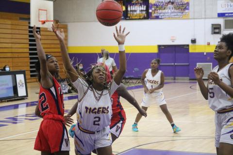 Columbia guard Na’Haviya Paxton is fouled by Vanguard’s Jadah Kingcade as she drives to the basket on Tuesday night. (JORDAN KROEGER/Lake City Reporter)