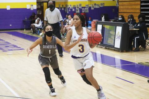 Columbia guard Camille Perry drives past Gainesville guard Layla Canales on Wednesday night. (JORDAN KROEGER/Lake City Reporter)