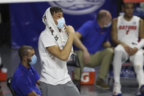 Florida's Keyontae Johnson is shown on the sidelines during a game on Jan. 19 in Gainesville. Florida standout Keyontae Johnson has one of the best seats in the O’Connell Center. He’s just a few feet from the court, close enough to hear calls, see screens coming and know where the ball needs to go next. (MATT STAMEY/Associated Press))