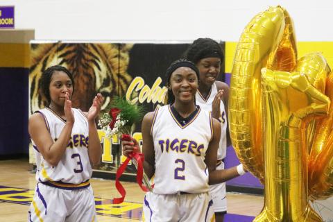 Columbia point guard Na’Haviya Paxton is congratulated by teammates after scoring the 1,000th point of her career during the second quarter of Thursday’s game against Countryside Christian. Paxton was presented with a bronze basketball trophy, balloons, flowers and a poster signed by all of her teammates that read, ‘Na’Haviya gets 1,000 buckets.’ (JORDAN KROEGER/Lake City Reporter)