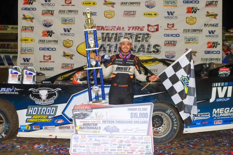 Kyle Larson poses with the first-place trophy after winning the General Tire Winter Nationals at All-Tech Raceway on Saturday night. Larson received a prize of $15,000. (LOVIN’ DIRTY PHOTOGRAPHY )