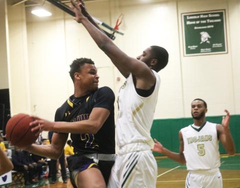 Columbia guard Amare Ferrell’s drive is stopped by a Lincoln defender Tuesday night in the Region 1-6A semifinals. (JORDAN KROEGER/Lake City Reporter)