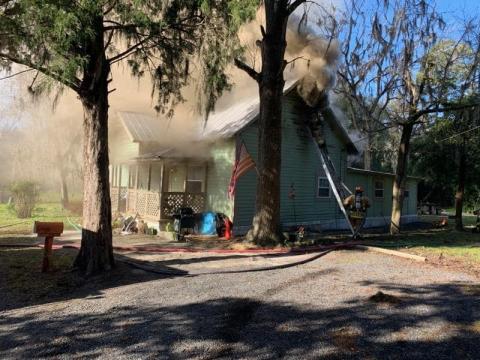 Firefighters with the Live Oak Fire Department battle a house fire on Lisle Ave. NE on Monday morning. The house sustained ‘considerable damage.’ (COURTESY SUWANNEE COUNTY FIRE RESCUE)