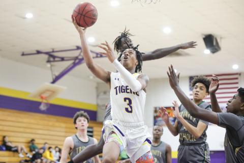 Columbia guard Charleston Ponds rises for a layup against Trinity Catholic on Tuesday night. (BRENT KUYKENDALL/Lake City Reporter)
