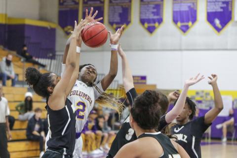 Columbia guard Na’Haviya Paxton is fouled by Buchholz forward Alicia Bryant during Friday’s District 2-6A championship game. (BRENT KUYKENDALL/Lake City Reporter)