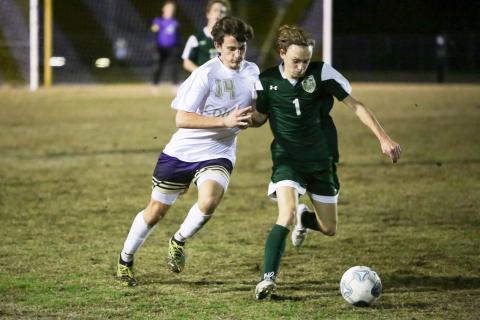 Columbia’s Trey Hingson chases after possession of the ball from Lincoln’s Brody Miller during Monday’s District 2-6A championship. (BRENT KUYKENDALL/Lake City Reporter)