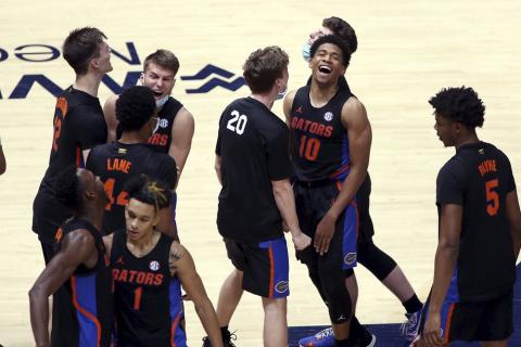 Florida players celebrate after a win against West Virginia on Jan. 30 in Morgantown, W.Va. (KATHLEE BATTEN/Associated Press)