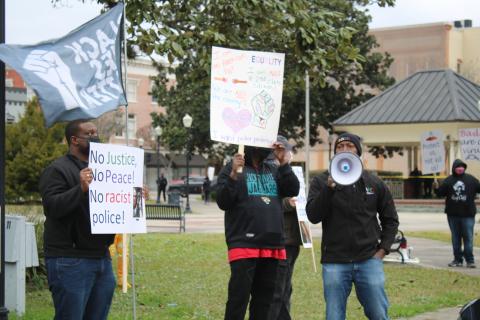 Sylvester Warren (right) uses a megaphone chanting 'No Justice, No peace; No racist police' during a Black Lives Matter protest where protesters we’re asking for police reform and better oversight. (TONY BRITT/Lake City Reporter)