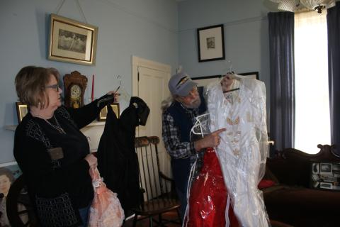 Kim Estergren, Lake City-Columbia County Historical Museum president-elect, and Harry Joiner, past president, work on moving dresses for the museum’s dress sale fundraiser today and Saturday. The sale will last from 9 a.m. to 1 p.m. both days at the museum, 157 SE Hernando Avenue. (TONY BRITT/Lake City Reporter)