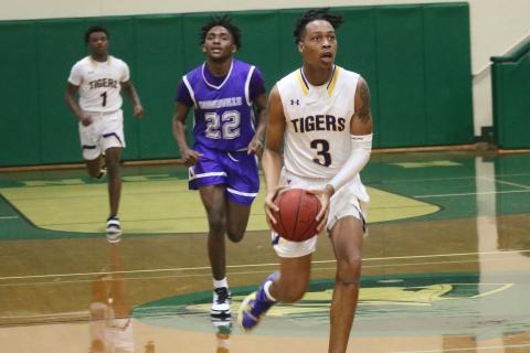 Columbia guard Charleston Ponds pushes the ball up the floor in transition against Gainesville during the District 2-6A semifinals Wednesday night at Lincoln High School. (JORDAN KROEGER/Lake City Reporter)