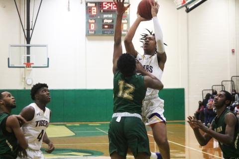 Columbia forward Charleston Ponds shoots over Lincoln forward Bryce Cummings during Friday’s District 2-6A championship. (JORDAN KROEGER/Lake City Reporter)