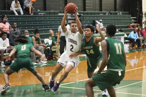 Columbia guard Amare Ferrell drives to the basket as Lincoln guard Jaylen Auston defends during the District 2-6A championship last Friday. (JORDAN KROEGER/Lake City Reporter)