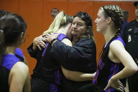 Branford forward Cera McElreath hugs head coach Carla Suggs following Tuesday’s loss to Trenton in the Region 3-1A finals. (MORGAN MCMULLEN/Lake City Reporter)