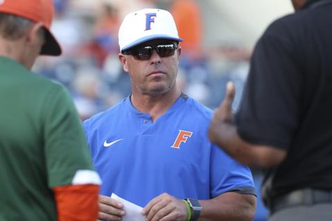Florida coach Kevin O'Sullivan meets with umpires before his team’s game against Florida A&M on March 4, 2020, in Gainesville. (AP FILE PHOTO)