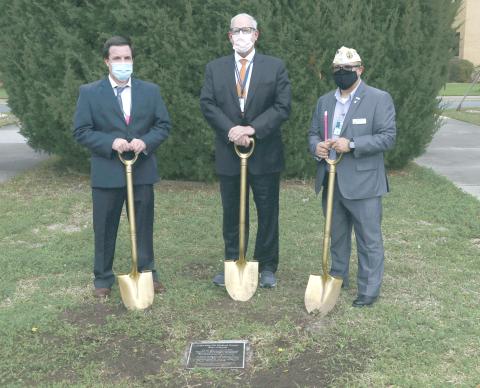 Lake City VA Medical Center Associate Director Chad Adams (from left), North Florida/South Georgia Veterans Health System Director Tom Wisnieski and Disabled American Veterans state commander Thomas Ayala took turns digging into the west lawn of the Lake City VA Medical Center yesterday. (MORGAN MCMULLEN/Lake City Reporter)