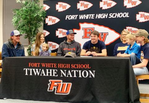 Fort White linebacker Colby Holton (middle) smiles during his signing ceremony Friday morning surrounded by his family. Holton signed with Warner University. (COURTESY)
