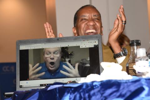 Burney Ratliff, reacts to being named the 2022 Columbia County Teacher of the Year, during his Zoom computer connection as Glenn Palmer, Pathways Academy assistant principal, smiles and cheers in the background. (COURTESY)