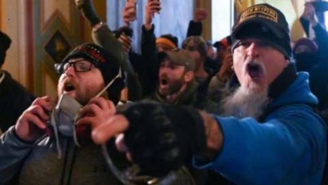 Indiana resident Jon Schaffer, right, is shown wearing a hat that says “Oath Keepers Lifetime Member” inside the U.S. Capitol Building during the Jan. 6, 2021, rioting, according to the FBI. He is now facing six federal criminal charges. (FBI/TNS)