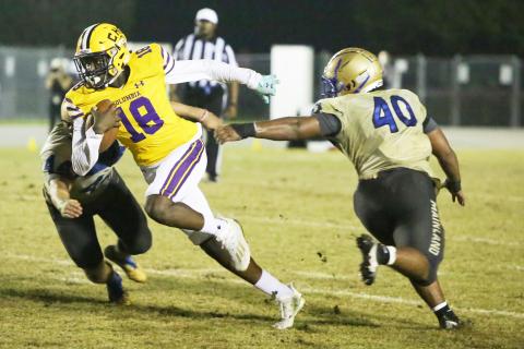 Columbia receiver Marcus Peterson fights through a Daytona Beach Mainland tackler during a Region 1-6A playoff last season. (FILE)