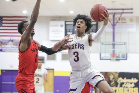 Columbia forward Charleston Ponds rises to the basket to shoot as Santa Fe center Ernest Ross defends during a game on Feb. 4. (BRENT KUYKENDALL/Lake City Reporter)