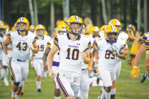 Columbia quarterback Kade Jackson leads his team on the field before a game last season. (FILE)