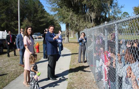 Madison DeSantis (from left), Casey Desantis and Gov. Ron DeSantis talk to Summers Elementary School students Thursday morning after the governor held a press conference at the Southside Sports Complex, across the street from Summers Elementary School, detailing recent covid vaccine distribution successes. (TONY BRITT/Lake City Reporter)